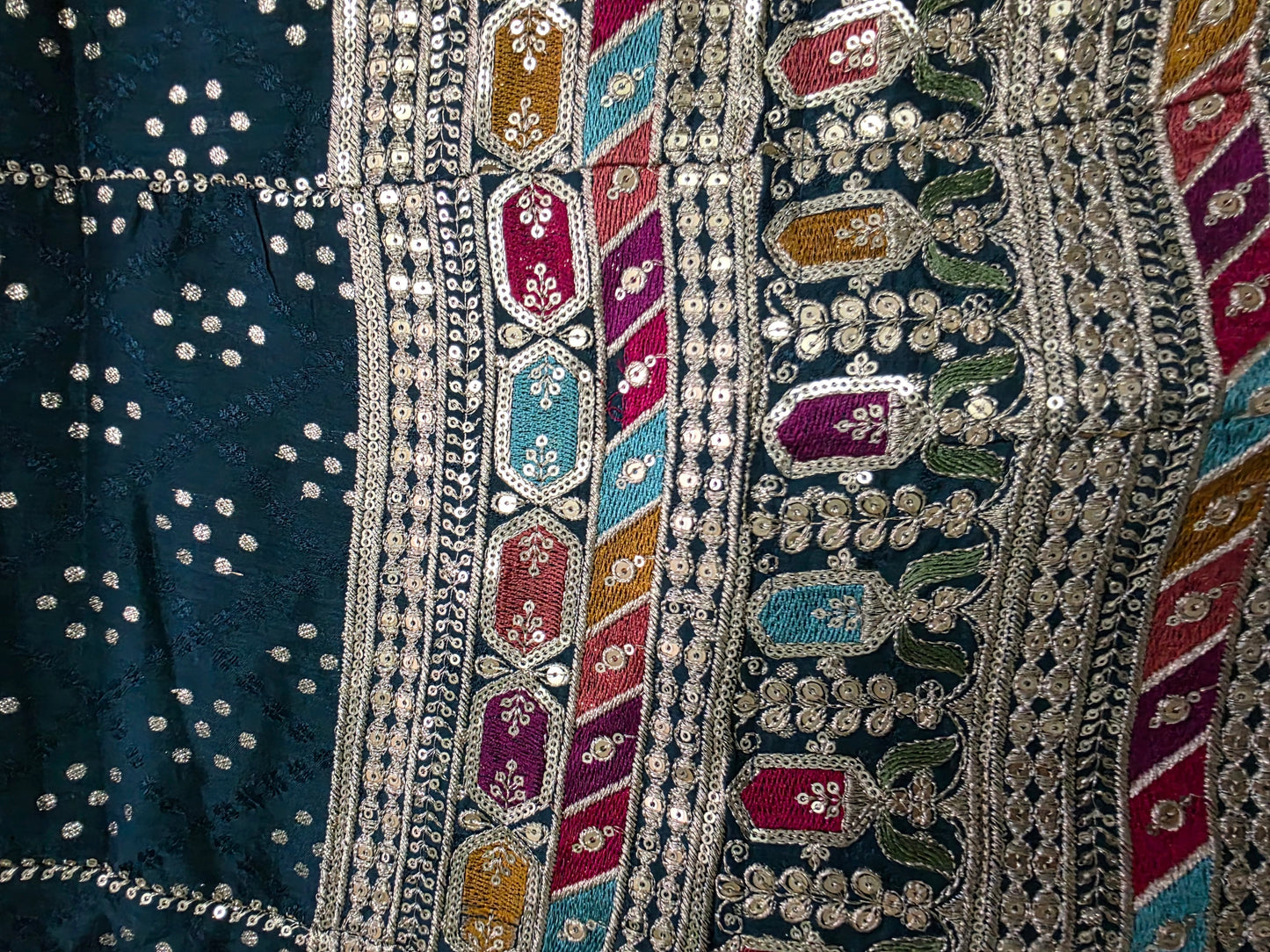 Border of bottle green semi-stitched lengha